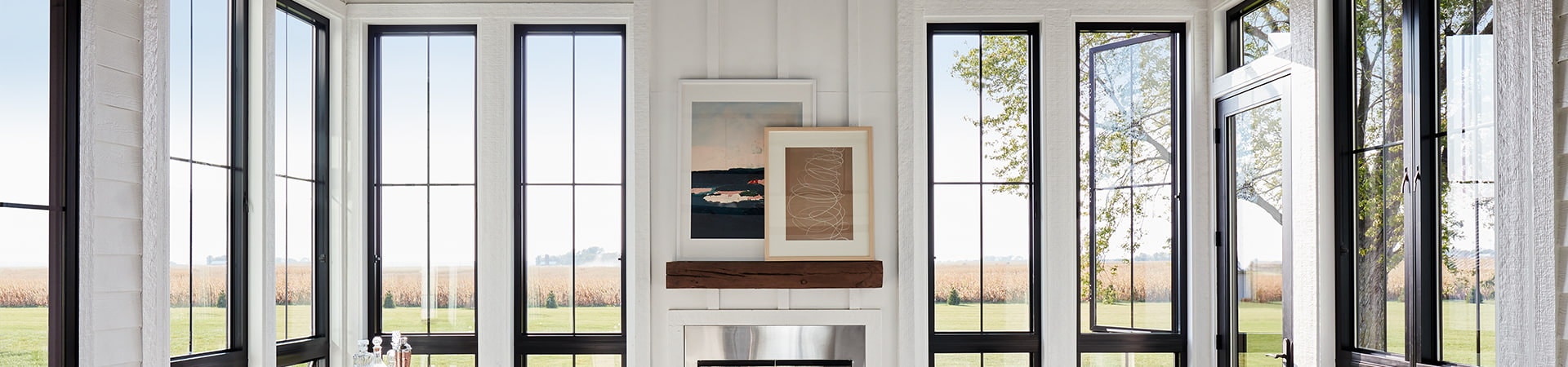 six black casement windows with custom grille patterns frame a contemporary living room