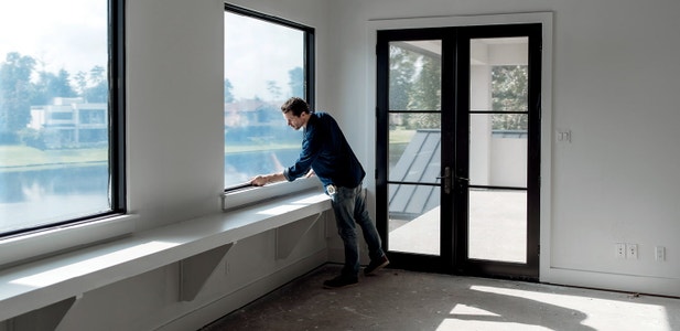 contractor measuring a window after installation