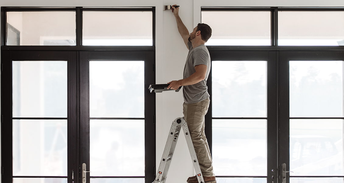 a do-it-yourselfer leveling a sliding patio door