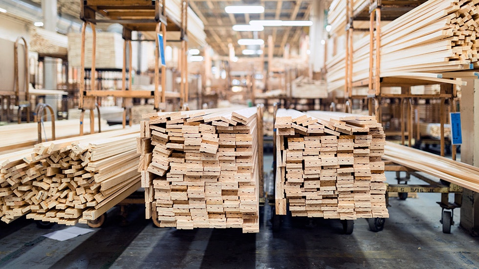 man wearing safety gear working on wood for a pella product