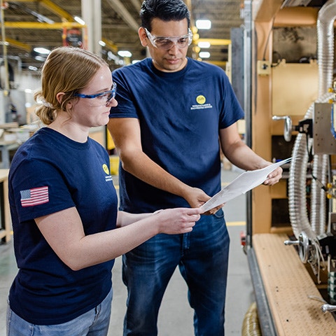 two pella manufacturing team members working together on a project