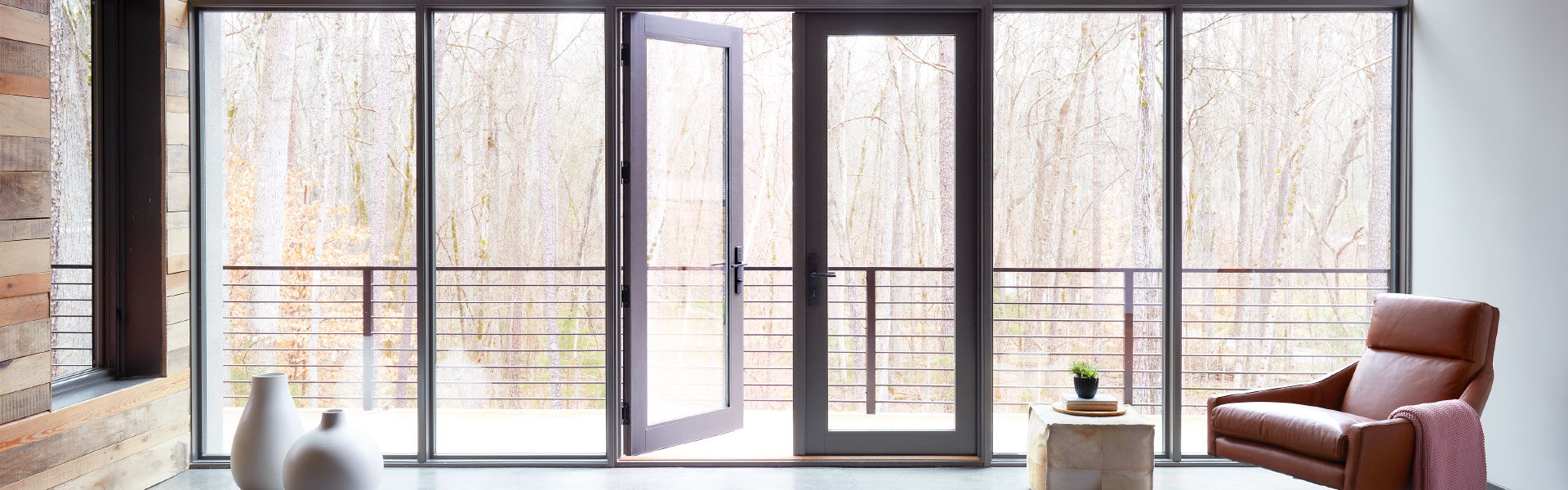wall of windows with a two-panel hinged door in the middle
