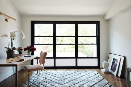 Three double hung windows beside each other in a home office space
