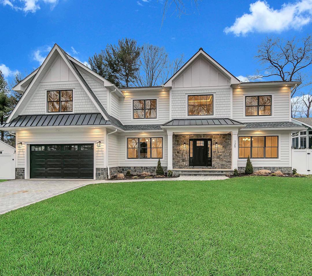 tan modern farmhouse exterior with black windows and doors
