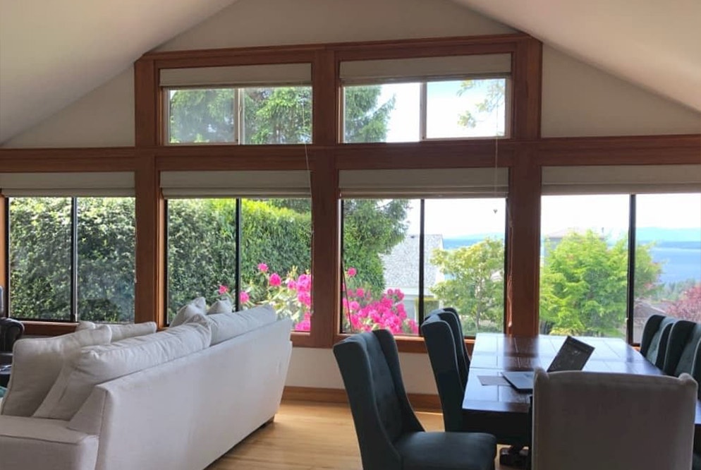 a configuration of windows that fill up an angled living room wall