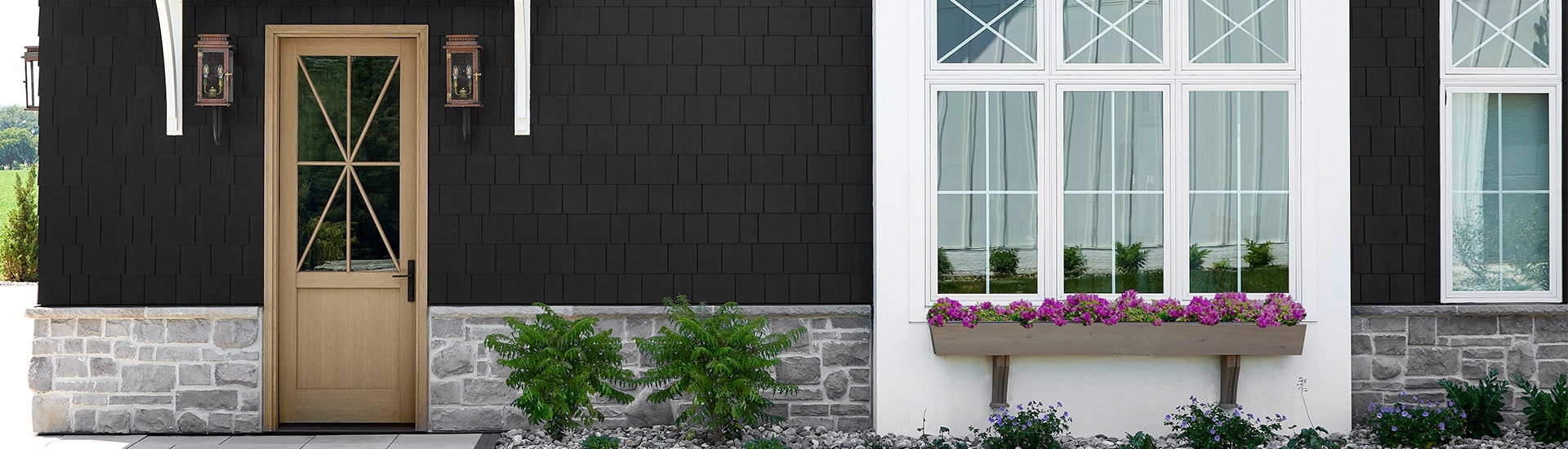 A tan wood front entry door with 3/4 glass shows off the front of a traditional home.