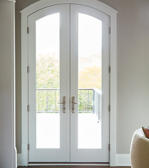 a two-panel arched hinged patio door on a typical entryway